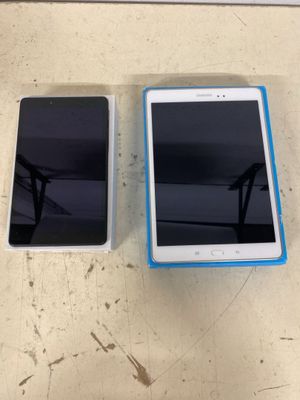 two cell phones sitting next to each other on a table