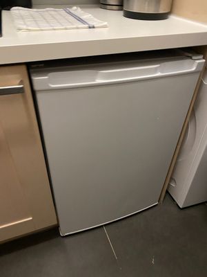 a white dishwasher sitting in the corner of a kitchen