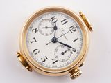 a close up of a gold watch on a white surface