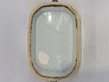 a small square bowl with a blue rim on a white surface