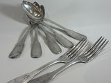 a lot of spoons and forks sitting on a table