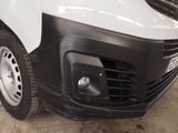 a white van parked in a garage next to other vehicles