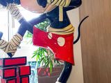 statue of mickey mouse in a karate pose on a table in an office