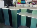 a desk with a computer on top of it in a room
