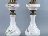 pair of white and gold vase lamps with floral designs on them