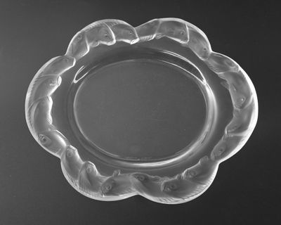 black and white photograph of a glass plate with a flower design