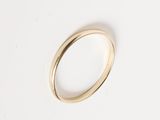 a close up of a gold ring on a white surface