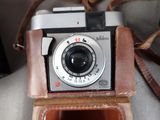 a brown leather case with a camera attached to it