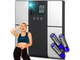the woman is standing next to a scale with batteries on it