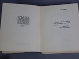 an open book with a poem on it on a table