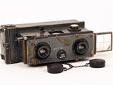 an old camera with a chain attached to it