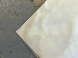 a piece of paper sitting on the floor next to a pair of scissors