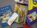a lot of books that are laying on the floor