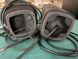 two headsets sitting on top of a green table