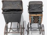 two old fashioned strollers sitting next to each other