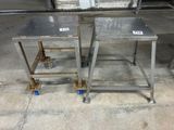 two metal tables on wheels in a warehouse