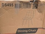 a cardboard box with a dining chair on top of it