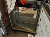 a small refrigerator with a bunch of wires on top of it