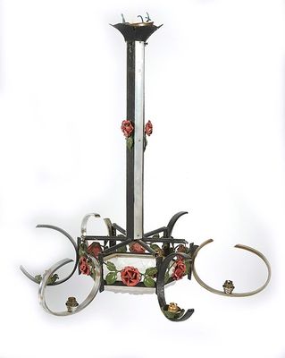 a chandelier with roses on it hanging from the ceiling
