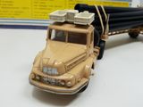 a toy truck that has a bunch of pipes on the back of it
