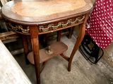 a wooden table with a red polka dot dress on it