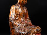 an image of a statue of a buddha sitting on top of a table