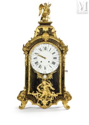 a gold clock with an angel on top of it