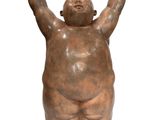 statue of a fat man holding his hands up in the air