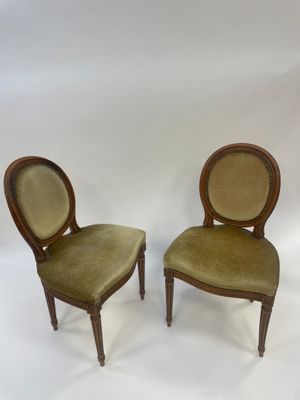 pair of antique chairs with green velvet upholstered seats