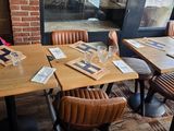 tables and chairs in a restaurant with menus on them