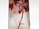a glass vase with a plant in it on a white surface