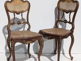 two chairs sitting next to each other on a white surface
