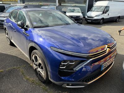 a blue car that is parked in a parking lot