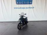 an image of a motorcycle parked in front of a auction sign