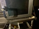 a microwave that is sitting on a shelf in a kitchen