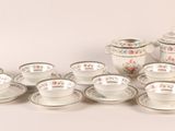 a lot of cups and saucers sitting on a table