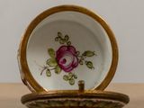 a close up of a small plate with a flower on it