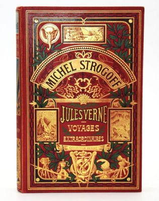 un livre rouge orné de lettres dorées et d'illustrations