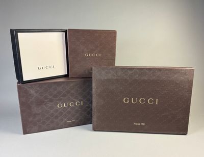 three boxes of gucci perfume sitting on top of each other