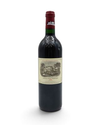 a close up of a bottle of wine on a white surface