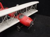 a toy airplane that is sitting on a black surface