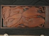 a wood carving of a woman holding a child
