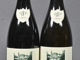two bottles of wine are sitting next to each other on a table