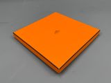 a close up of an orange box on a gray surface