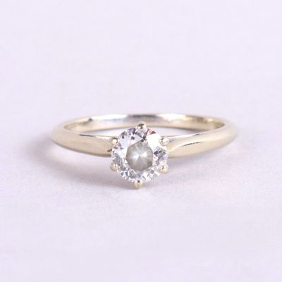 une bague de fiançailles ornée d'un diamant blanc sur fond blanc