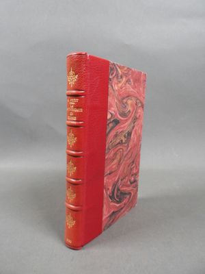 a red book with gold trim and a red cover