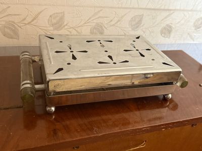 a small metal box on top of a wooden table