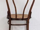 an image of a wooden chair with a wicker seat