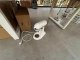 a white blender sitting on the floor next to a box