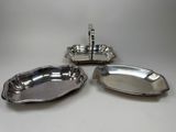 a set of three silverplated dishes on a stand